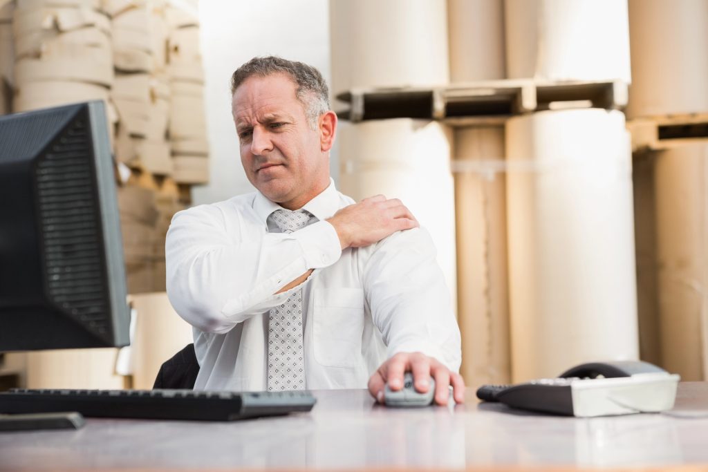 man holding his shoulder in pain